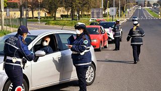 Members of the Rome Local Police check the documents and the self-declarations of motorists on the Via Pontina, in Rome, on March 21, 2020