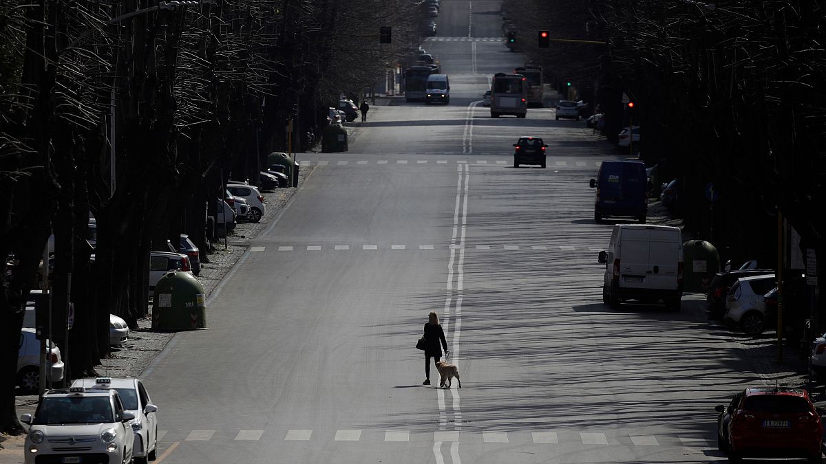 A woman walks her dog in a Rome neighbourhood amid a nationwide lockdown in italy