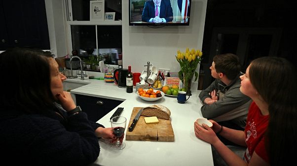Una familia escucha el discurso televisado del primer ministro Boris Johnson Una familia escucha el discurso televisado del primer ministro Boris Johnson