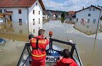 Members of the German Life-Saving Association patrol onboard a boat through the flooded streets in Deggendorf, Bavaria, 5 June 2013 