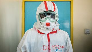 A doctor gets ready with protective gears before visiting the ward for quarantined people who had close contacts with the Kenyan patient of the COVID-19