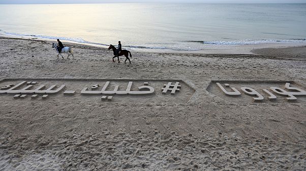 شعار رملي على طول شاطئ في مدينة غزة يدعو الناس إلى البقاء في البيوت شعار رملي على طول شاطئ في مدينة غزة يدعو الناس إلى البقاء في البيوت