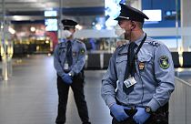 Hungarian police officers wearing protective face masks stand on guard in the hall of Budapest's Liszt Ferenc Airport of on February 5, 2020