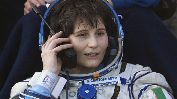 Italian astronaut Samantha Cristoforetti speaks on a satellite phone outside of the Soyuz AFP PHOTO / POOL / IVAN SEKRETAREV (Photo by IVAN SEKRETAREV / POOL / AFP) Italian astronaut Samantha Cristoforetti speaks on a satellite phone outside of the Soyuz AFP PHOTO / POOL / IVAN SEKRETAREV (Photo by IVAN SEKRETAREV / POOL / AFP)