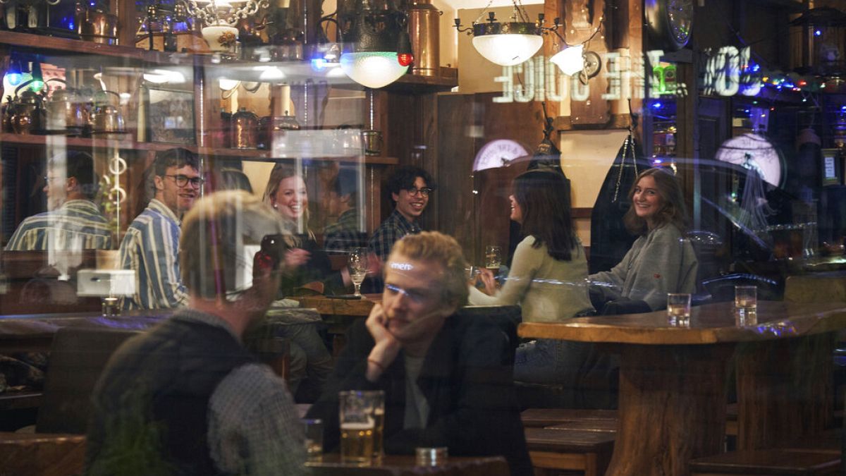 People sit in a bar in Stockholm on March 25. The streets of Sweden's capital are quiet but not deserted. Sweden has some of the most relaxed measures in Europe on coronavirus