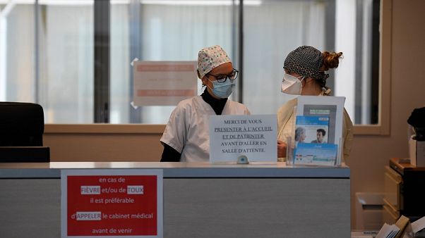 Nurses wearing protective face masks are pictured Nurses wearing protective face masks are pictured