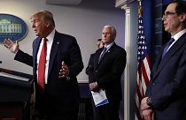 Donald Trump speaks about the coronavirus in the James Brady Briefing Room, Wednesday, March 25, 2020, in Washington as Mike Pence and Treasury Secretary Steven Mnuchin listen