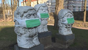 Coronavirus: masked statues make cultural comment and health reminder in Lithuania 