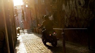 A man rides his motorbike in Lisbon