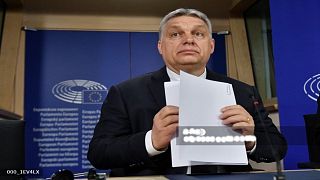 Hungarian Prime Minister Viktor Orban, second right, welcomes the staff of the Chinese Suparna Airlines at Liszt Ferenc International Airport in Budapest, Hungary