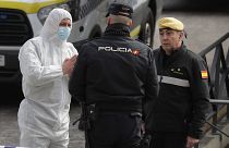 A member of UME, left, talks with a police officer at a ice-skating rink in Madrid, Spain, Tuesday, March 24, 2020.