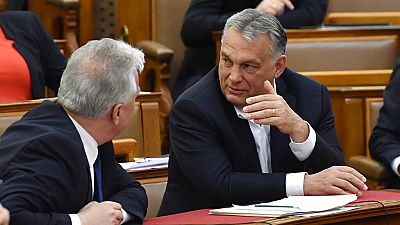 Hungarian Prime Minister Viktor Orban, right, chats with his deputy Zsolt Semjen during a plenary session of the Parliament in Budapest, Hungary