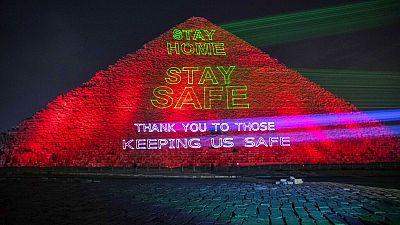 Messages of support for health workers are displayed on a pyramid in Egypt