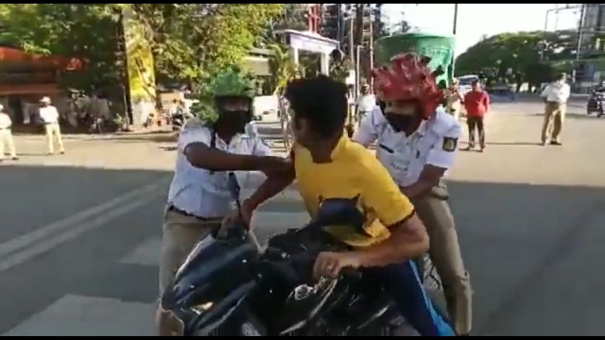 Indian police wear coronavirus helmets to spread lockdown message