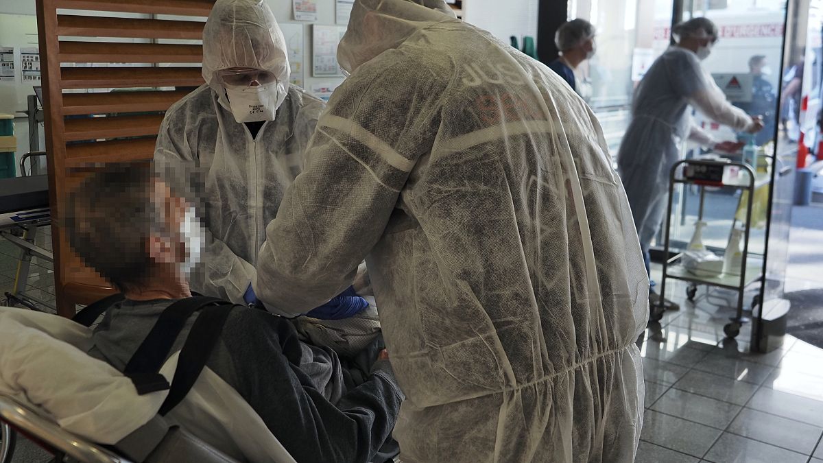 Medical personnel prepare a Covid-19 infected patient at the universitary hospital (CHU) of Tours, France, March 31, 2020 (Photo by GUILLAUME SOUVANT / AFP)