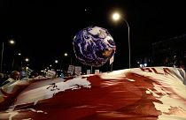 A balloon in the shape of the Earth is pictured during a mass climate protest during the COP25 summit in Madrid, December 6, 2019. (Photo by CRISTINA QUICLER / AFP)