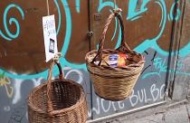 Baskets of solidarity lowered from Naples balconies amid coronavirus chaos