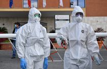 Female wearing a protective mask and overalls stand at the entrance of the Nomentana hospital in Fonte Nuova - Tor Lupara, near Rome, Italy