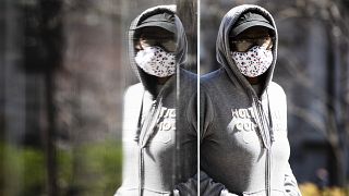 A person wearing protective masks due to coronavirus concerns walks in Philadelphia, Thursday, April 2, 2020.