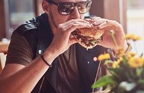 Man eating a beef burger