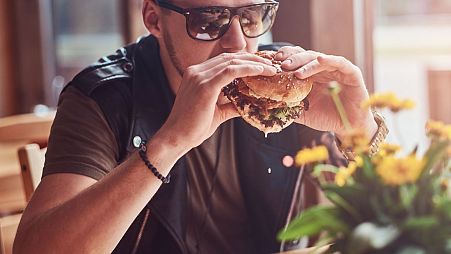 Man eating a beef burger