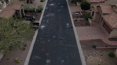 Spreading the love: Sisters cover road with hearts to lift spirits amid coronavirus pandemic