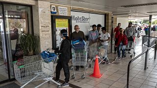 People queue to enter a supermark in Cyprus' capital Nicosia