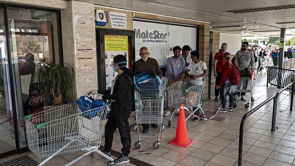 People queue to enter a supermark in Cyprus' capital Nicosia People queue to enter a supermark in Cyprus' capital Nicosia