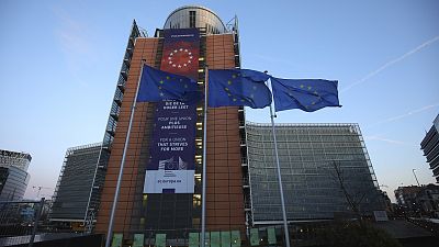 European Union flags flap in the wind outside EU headquarters in Brussels