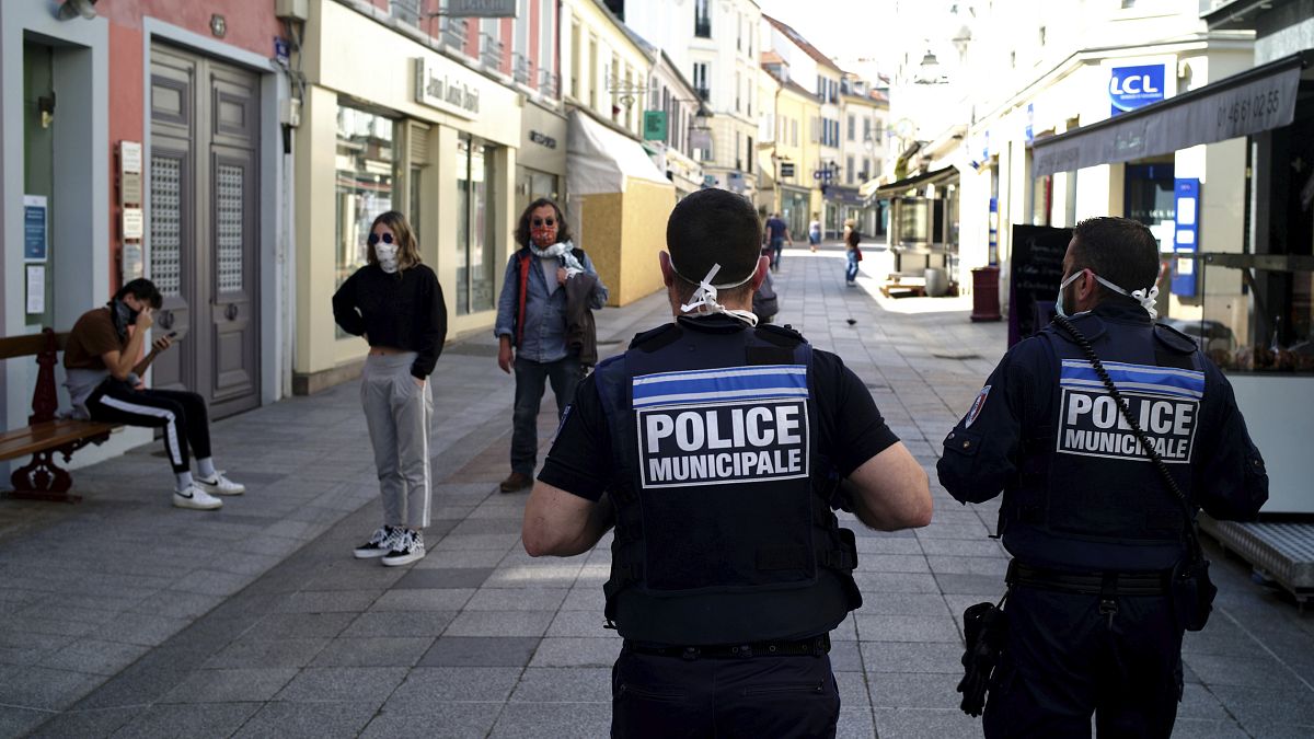 Municipal police officers patrol in a street of Sceaux during nationwide confinement measures to counter the Covid-19, in Sceaux, south of Paris, Wednesday, April 8, 2020.