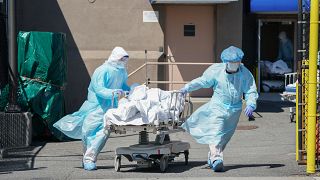 Bodies are moved to a refrigeration truck serving as a temporary morgue at Wyckoff Hospital in the Borough of Brooklyn on April 6, 2020 in New York.