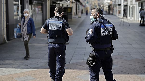 Local police patrol as pedestrians wear face masks in the main street of Sceaux, south of Paris, on April 8, 2020 Local police patrol as pedestrians wear face masks in the main street of Sceaux, south of Paris, on April 8, 2020