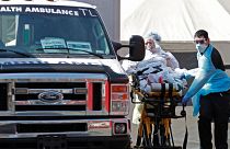 A patient is wheeled to an ambulance in New York