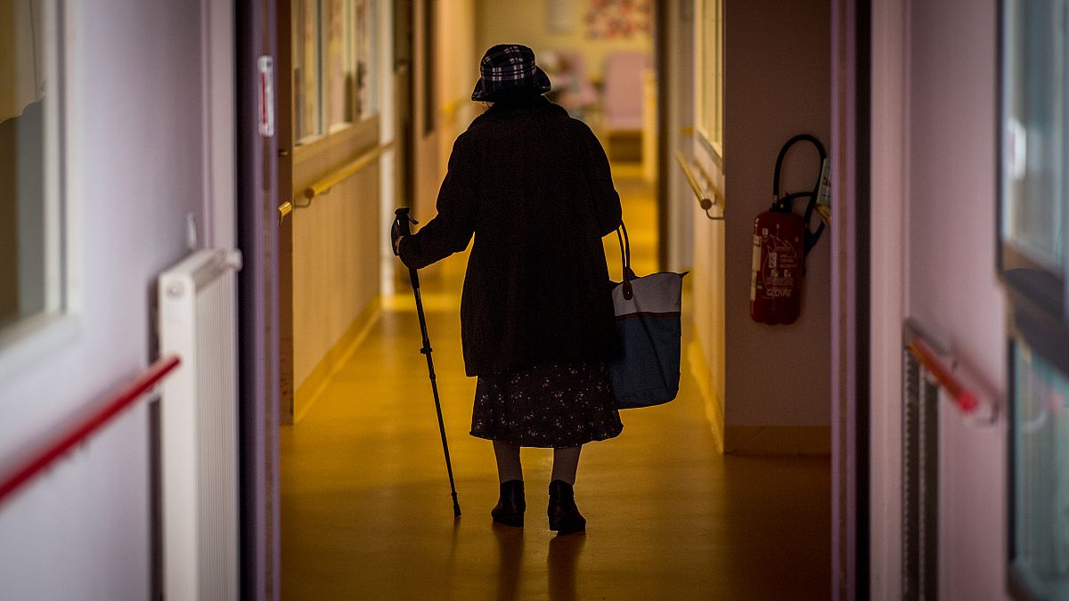 A resident walks down a corridor in Housing Establishment for Dependant Elderly People in Brest, western France