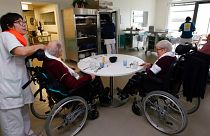 A care worker looks after residents of the Maharin nursing home of Anglet, southwestern France, Tuesday, Jan.30, 2018.
