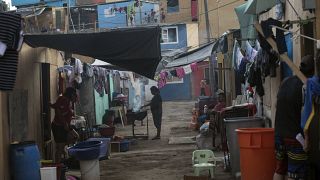 A woman cooks outside her house in a shanty town of Lima, Peru, Thursday, April 2, 2020. The country has ordered a lockdown amid a state of emergency due to the coronavirus..