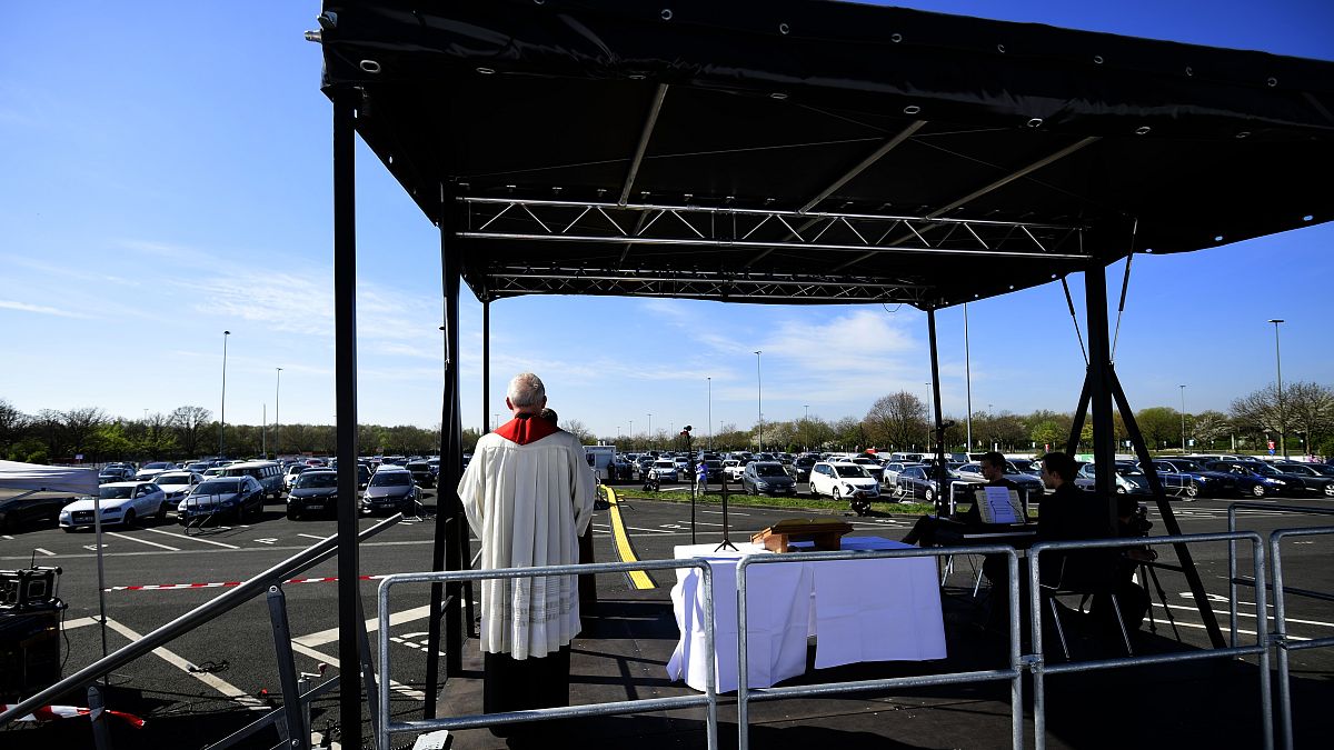Pastor Frank Heidkamp holds an easter service under the open sky in Duesseldorf drive-in cinema, western Germany, on April 10, 2020