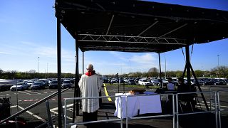 Pastor Frank Heidkamp holds an easter service under the open sky in Duesseldorf drive-in cinema, western Germany, on April 10, 2020