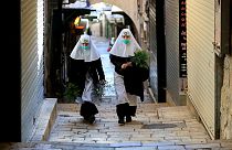 Nuns walk along the Via Dolorosa 