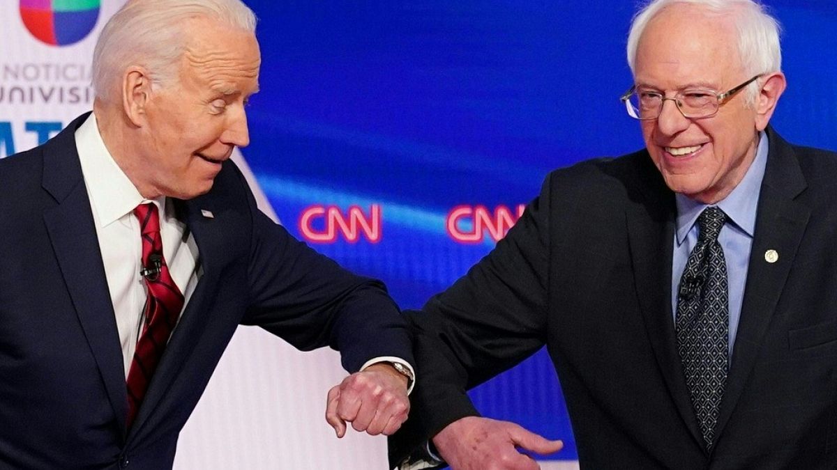 (US vice president Joe Biden (L) and Senator Bernie Sanders greet each other with a s
