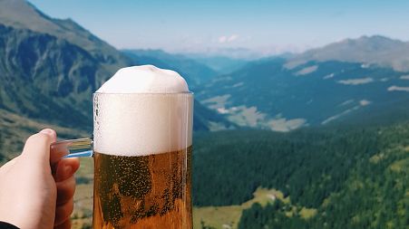 A cold beer looking over the mountains in Europe