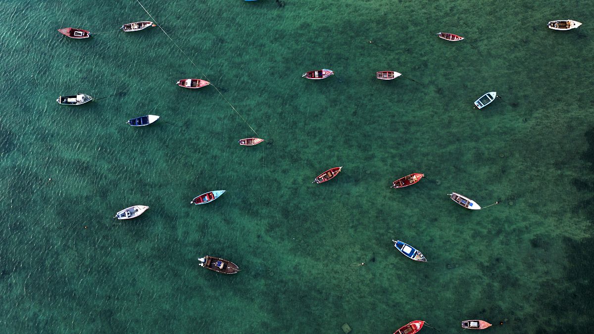 An aerial view shows fisher boats at the harbour in Sal Rei at Boa Vista island, Cape Verde, on January 06, 2020. (Photo by INA FASSBENDER / AFP)
