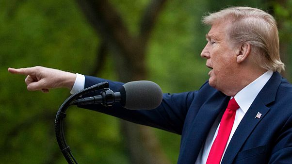 President Donald Trump points to a question as he speaks about the coronavirus in the Rose Garden of the White House, Tuesday, April 14, 2020, in Washington.