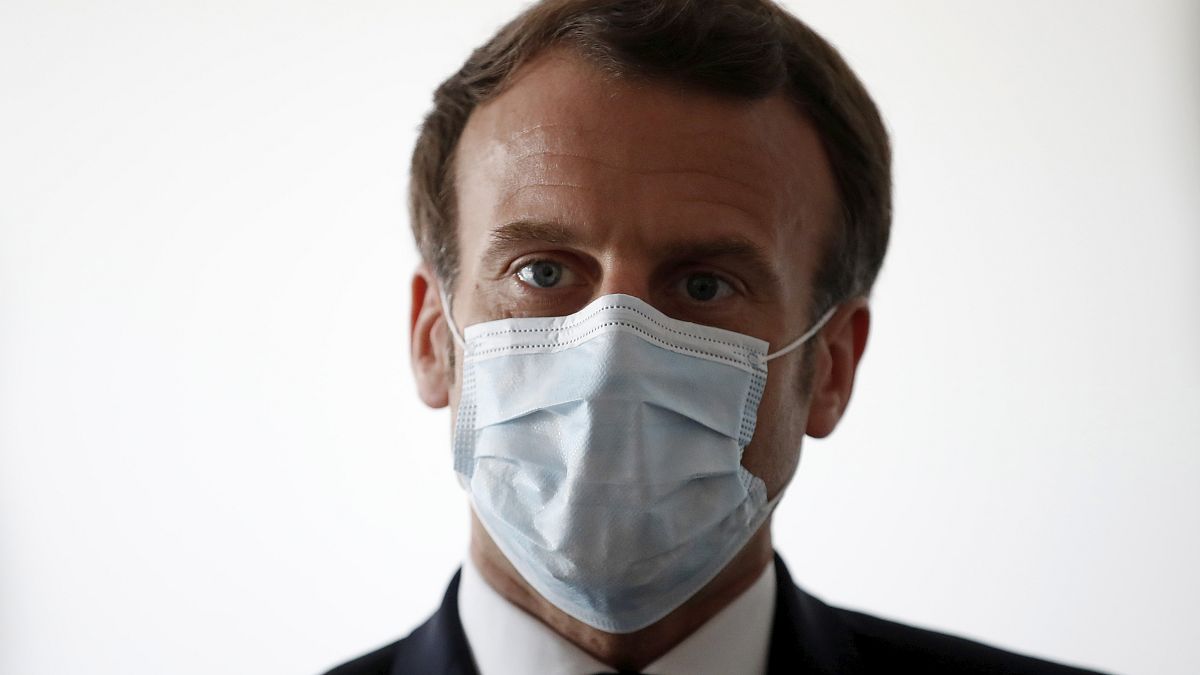 French President Emmanuel Macron wear a protective face masks as he visits a medical center in Pantin, near Paris, Tuesday April 7, 2020.