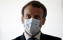 French President Emmanuel Macron wear a protective face masks as he visits a medical center in Pantin, near Paris, Tuesday April 7, 2020.