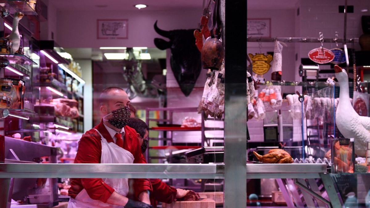 A butcher works in his shop in Paris, on April 16, 2020