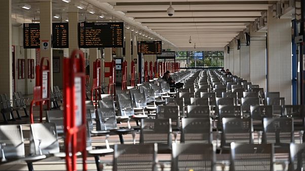 A person sits on a seat in an otherwise empty bus station in Huddersfield, northern England A person sits on a seat in an otherwise empty bus station in Huddersfield, northern England