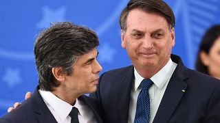Brazilian President Jair Bolsonaro (R) embraces his new Health Minister Nelson Teich during his swearing-in ceremony at Planalto Palace in Brasilia, on April 17, 2020