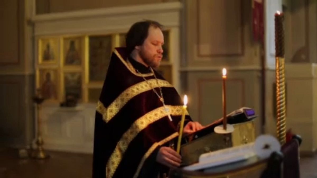 Orthodox priest conducting church service in Moscow for online worshippers