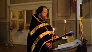 Orthodox priest conducting church service in Moscow for online worshippers